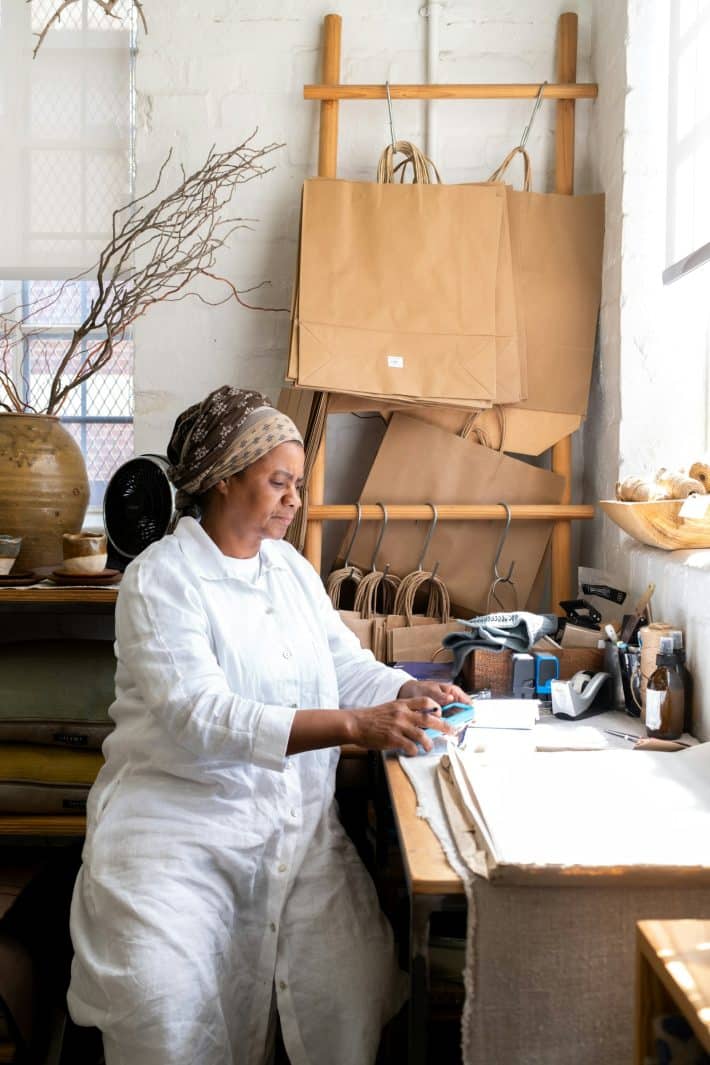 Etsy shop owner working at a desk with craft supplies — using the right tools to grow a handmade business in 2026